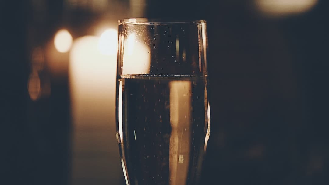Champagne bubbles in a flute on dark background